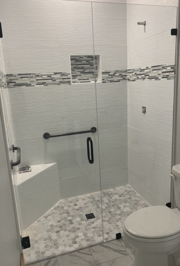 Modern bathroom remodel in Austin TX with walk-in shower, tile walls, and custom vanity by ABC Austin Home Renovations