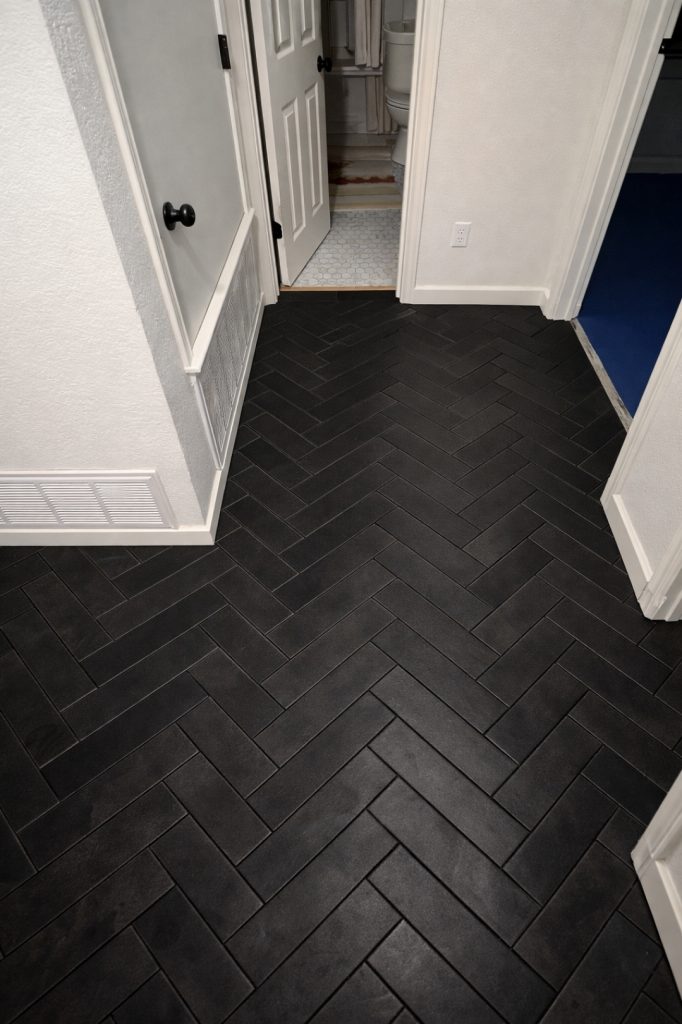 Profesional black tile flooring installation finished in residential home hallway in Austin Texas 