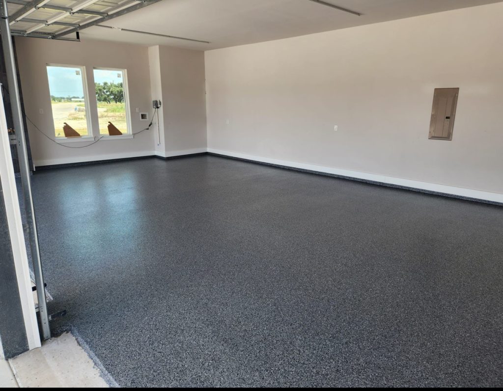 Epoxy flake garage floor installation in Austin TX with decorative gray flake coating