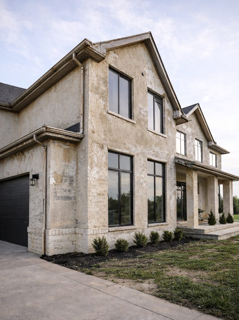 Exterior house with worn and peeling paint before professional exterior painting service in Georgetown TX